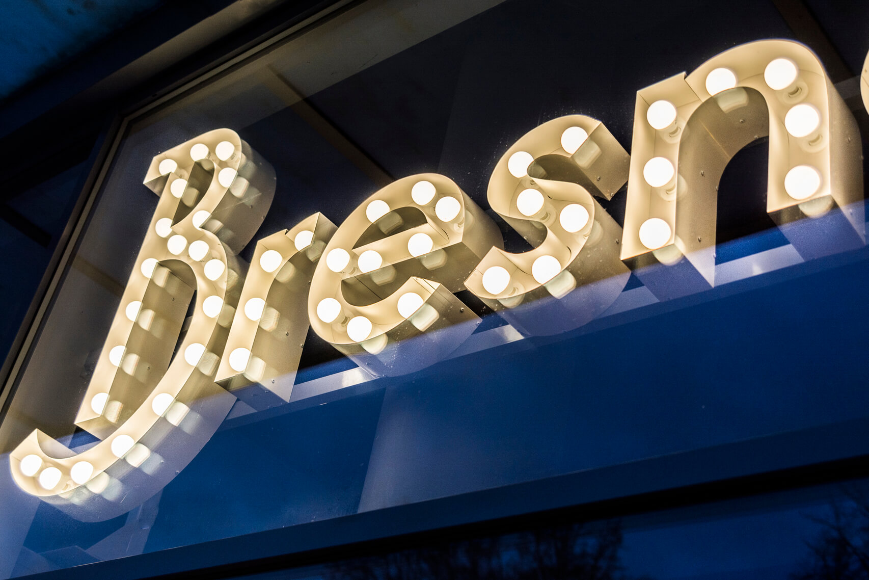 Bresno - letters with light bulbs behind glass